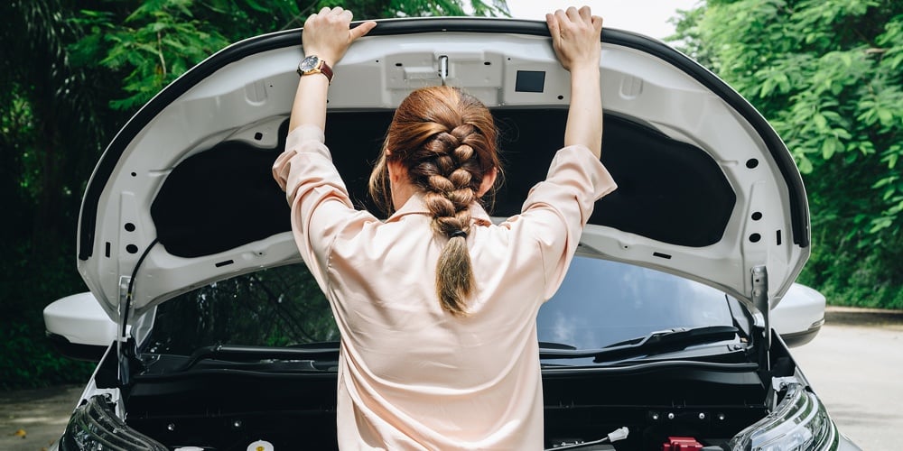 Rear View Of Asian Woman Opened Car Hood For Looking The Problem Of Car Breakdown While Waiting For